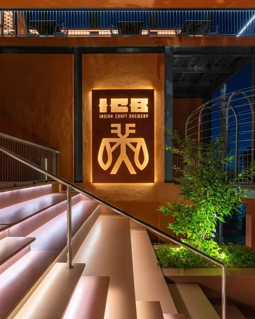 The backlit ICB Indian Craft Brewery sign with the Vari mark above the terracotta staircase