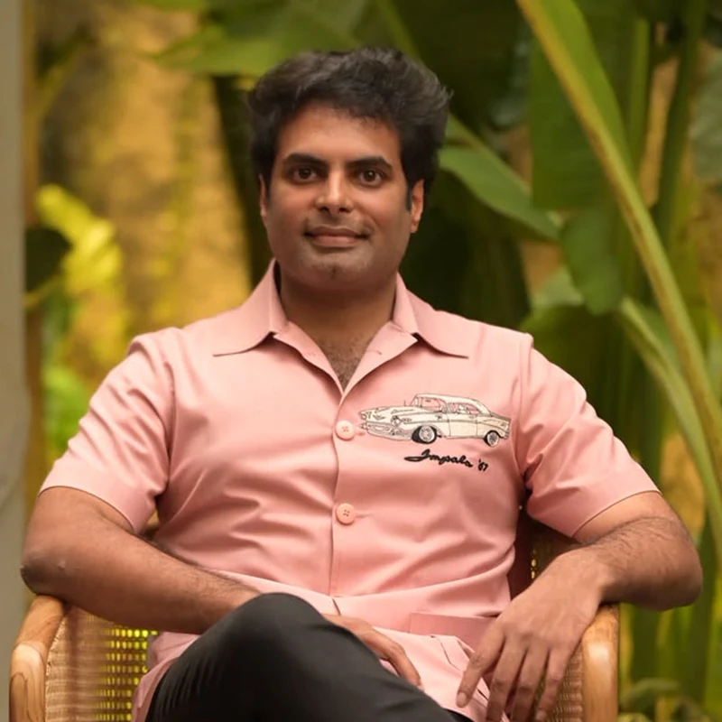 Vasireddy Rohith of ICB, seated in a cane chair among tropical plants